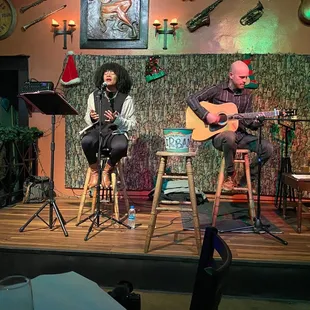 a man and a woman singing on stage
