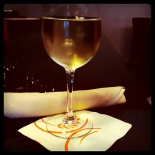 a glass of wine on a napkin