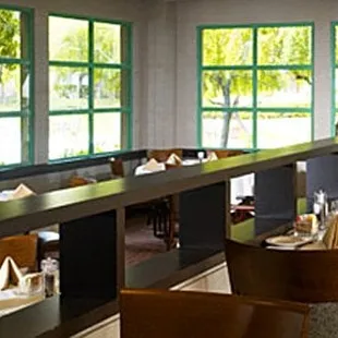 a dining area with tables and chairs