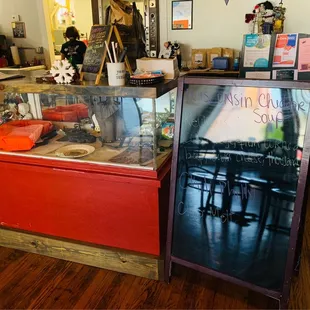 Restaurant ordering counter with daily specials (blackboard) and various decorations