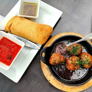 a skillet with meatballs and sauce