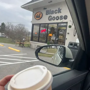 a hand holding a cup of coffee