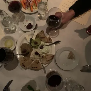 a plate of food and a glass of wine