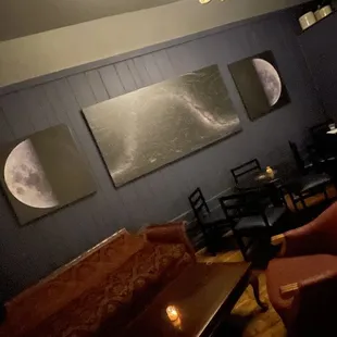 a living room with couches and a chandelier