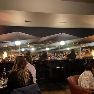 a group of people sitting at a bar