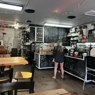 a woman standing in a coffee shop