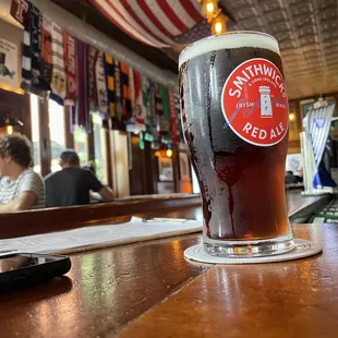 a pint of beer on a bar