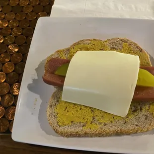 Hot Dog on Rye bread with mustard and cheese and a pickle. Pretty good during Dodgers games