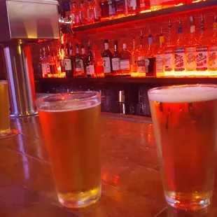 a row of beer glasses on a bar