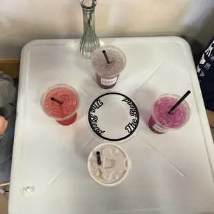 two people sitting at a table with drinks