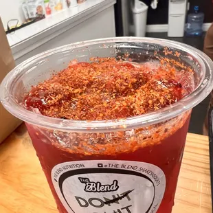 a plastic cup filled with sauce