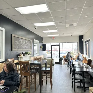 a woman sitting at a table in a restaurant