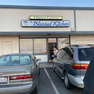 two cars parked in front of the building