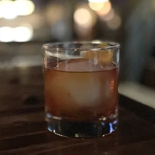 a glass of whiskey on a table