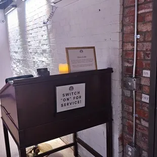 a wooden desk with a sign on it