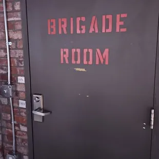 a door with the word brigade room written on it