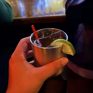 a person holding a cup with a drink in it