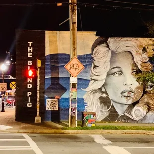 a woman&apos;s face painted on the side of a building