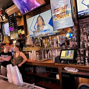 a man and a woman behind the bar