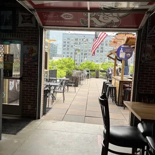 a patio area with tables and chairs
