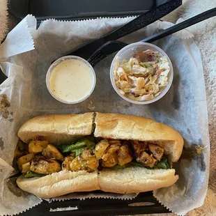 Grilled chicken hoagie with coleslaw and side of ranch dressing.