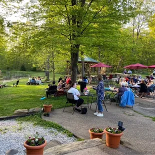 a crowd of people enjoying a picnic in the park