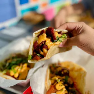 a hand holding a burrito