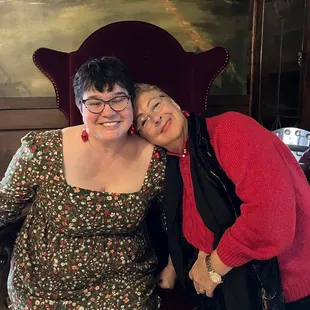 Incredible period furniture and mural behind 2 lovelies!