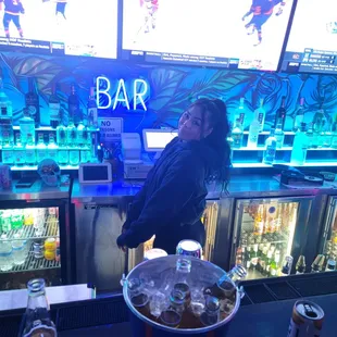 a woman standing at a bar