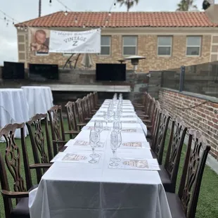 Patio set up with banquet table and also high-tops