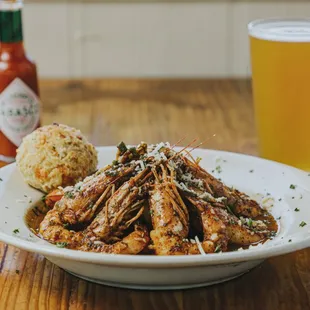 a plate of shrimp and a beer