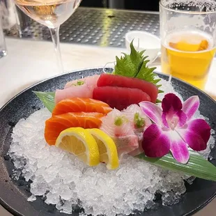 a plate of sushi and a glass of wine