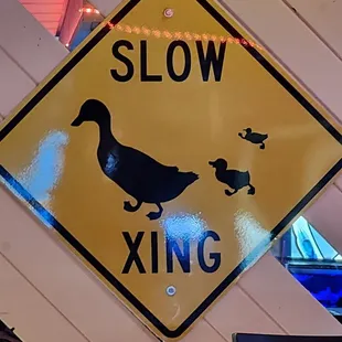 a yellow duck crossing sign