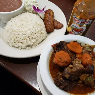 Oxtail stew with white rice, stew beans, plantains, and potato salad... O.M.G! The food is AMAZING!!