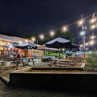 Outside. String-lit open-air patio at night. They also have a fully enclosed patio which you can see in this picture as well.