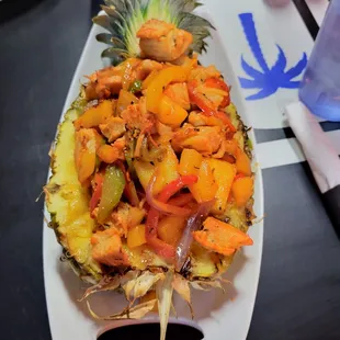a pineapple with shrimp and vegetables