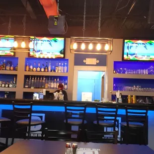 a bar with multiple televisions