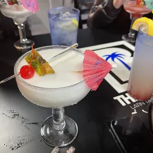 a woman holding a cocktail