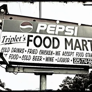 a black and white photo of a pepsi sign