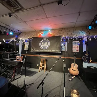 a stage with a guitar and microphones