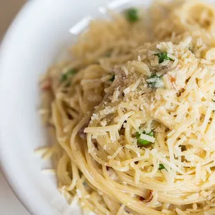 a bowl of spaghetti with meat and cheese