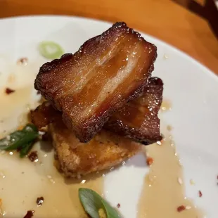 Pork belly bites on fried grit cakes