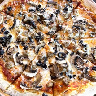 a pizza with mushrooms and olives