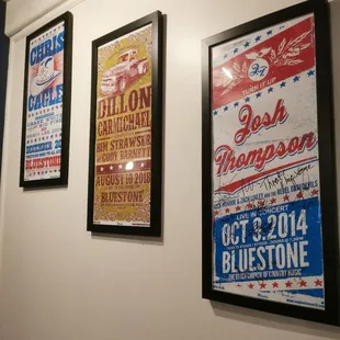 posters on the wall of a music venue