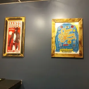 two framed posters on the wall
