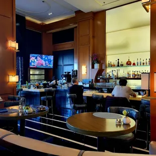 a bar with people sitting at it