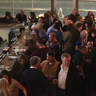 a large group of people at a bar