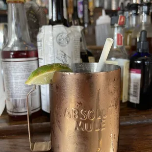 a copper mug with a lime wedge in it