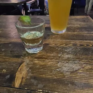 a glass of beer and a bowl of lime