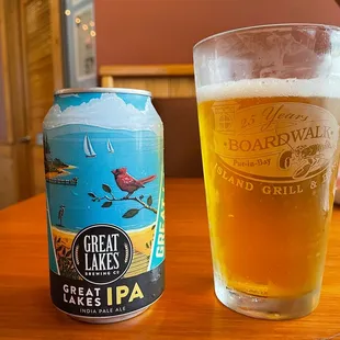a glass of beer and a can of great lakes ipa